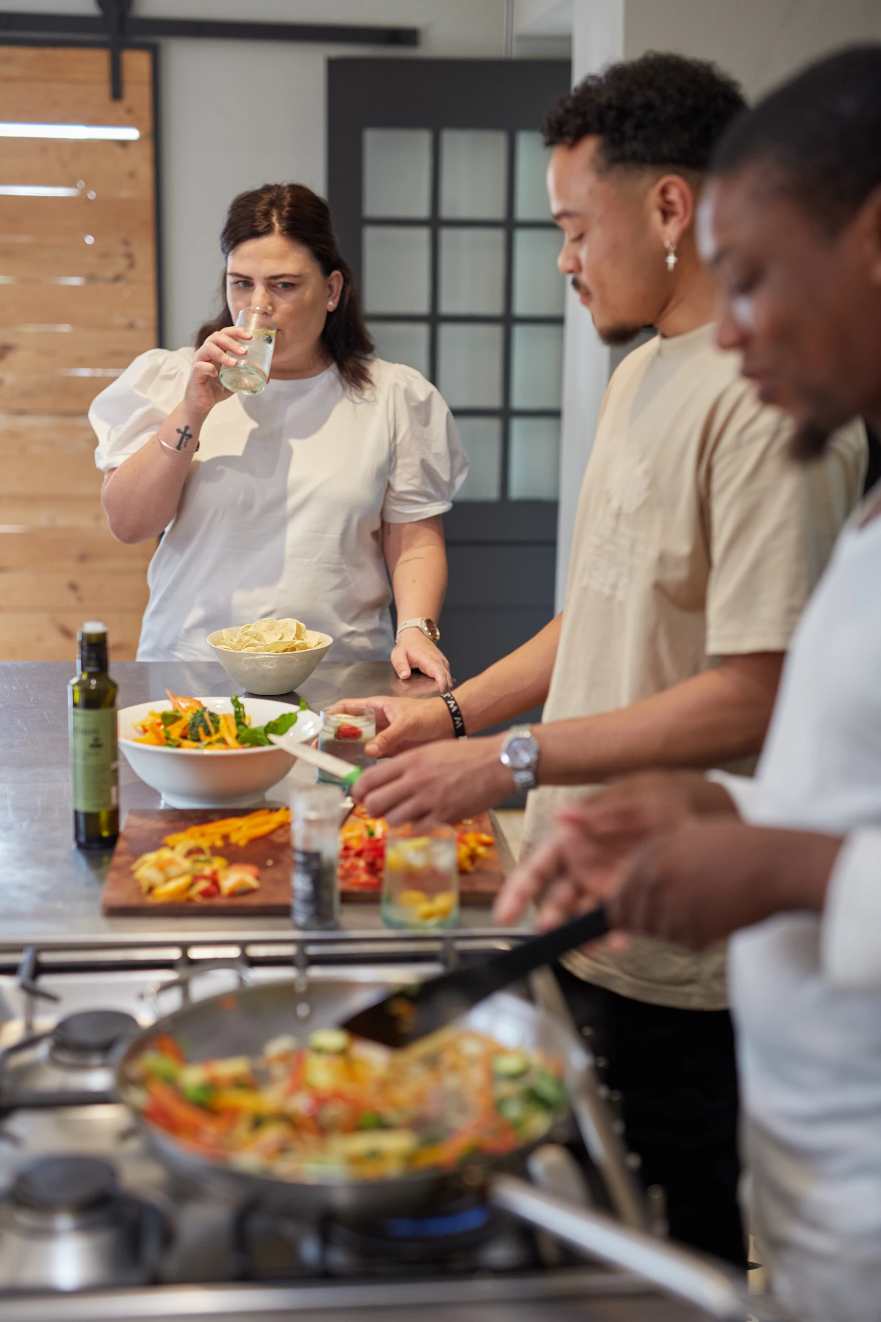 Friends cooking together in a bright kitchen