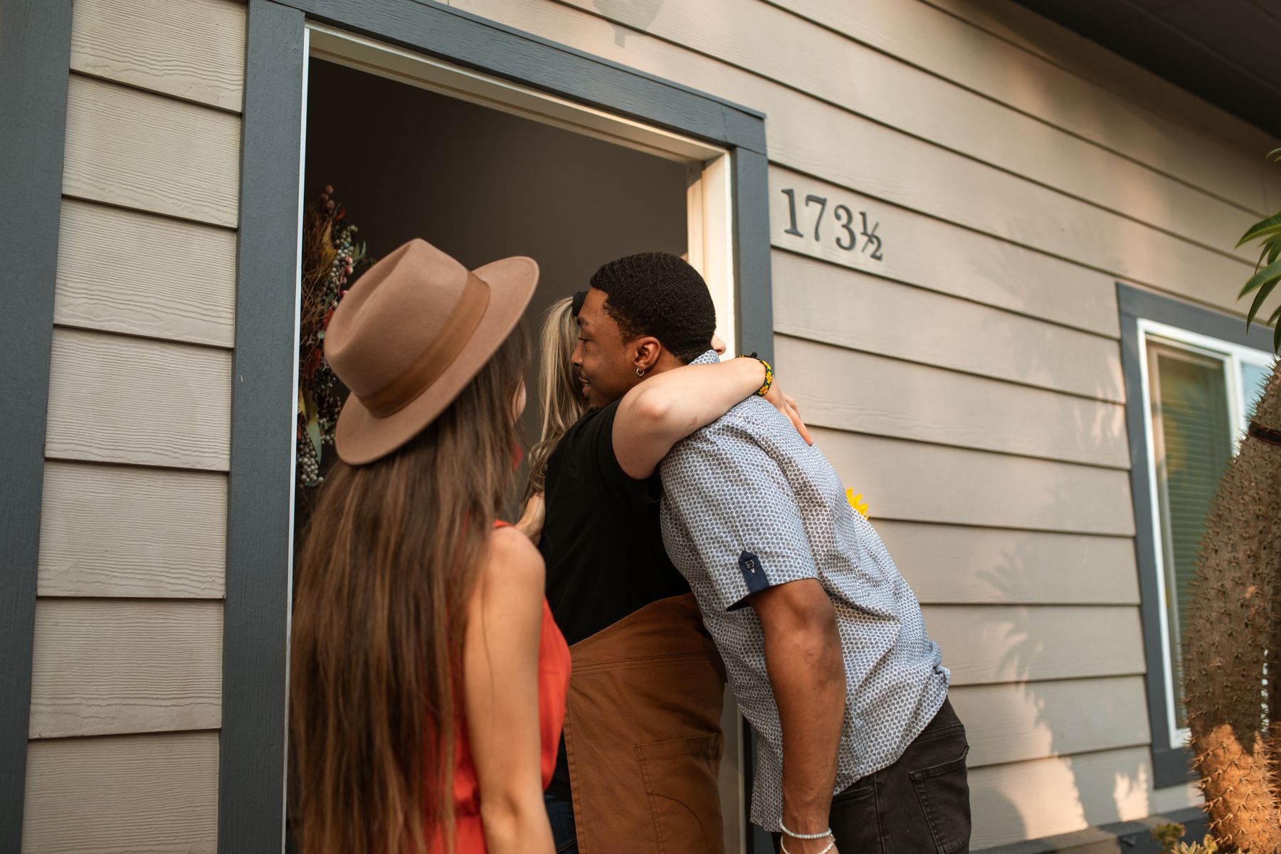 Friends greeting one another at a doorway